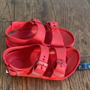 Kids red Birkenstock sandals.